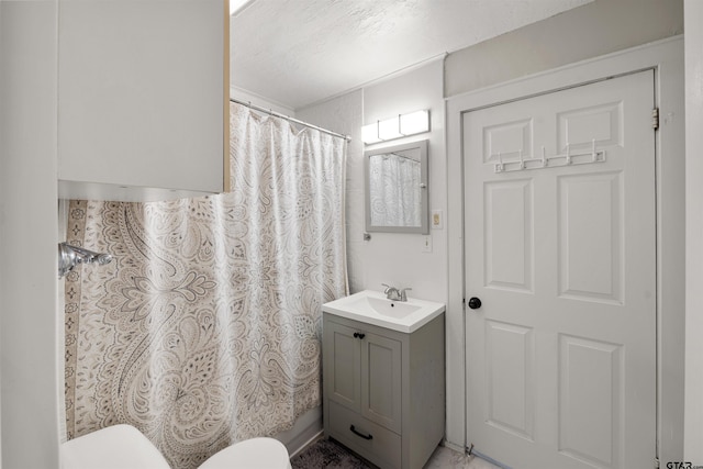 bathroom featuring vanity, toilet, and a shower with curtain