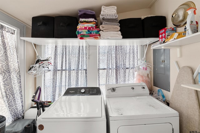 clothes washing area featuring washer and clothes dryer and electric panel