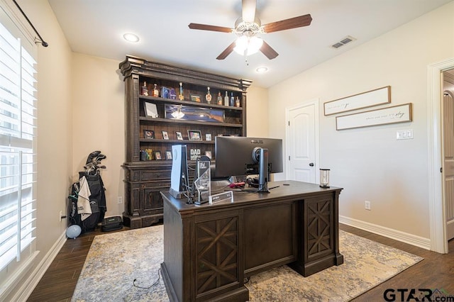 office with dark wood-style floors, visible vents, baseboards, and a ceiling fan