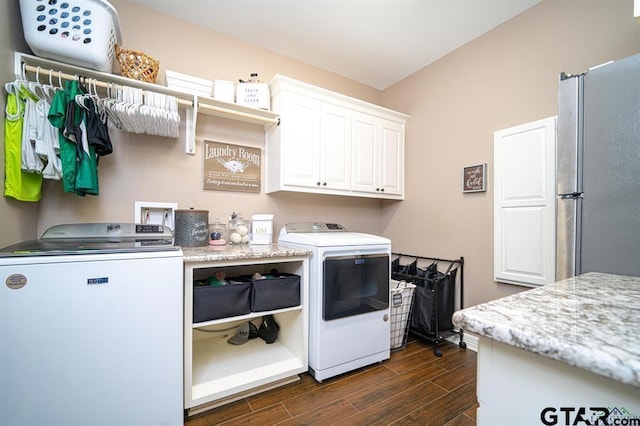 laundry area with washer and dryer, wood finish floors, and cabinet space