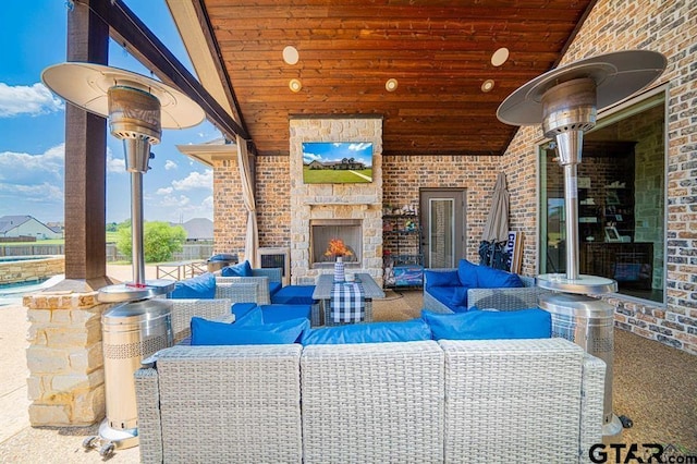 view of patio with an outdoor living space with a fireplace