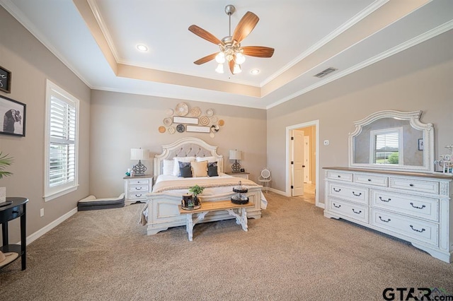 bedroom featuring light carpet, a raised ceiling, visible vents, and crown molding