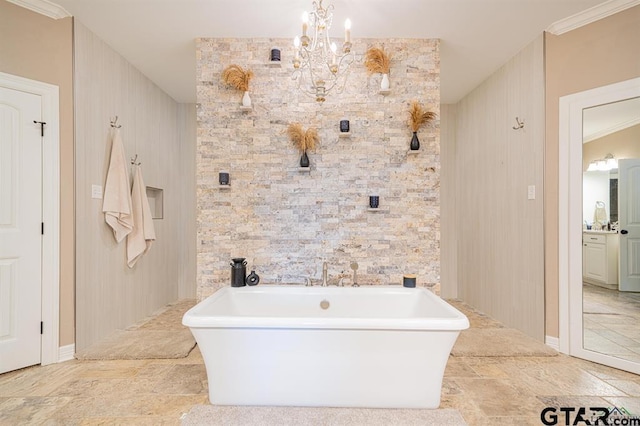 bathroom with a freestanding bath, a notable chandelier, and crown molding