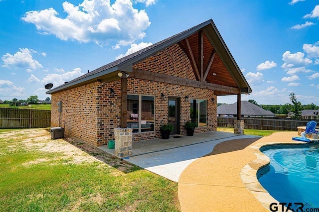 view of pool with a patio area, a fenced backyard, a fenced in pool, and a lawn