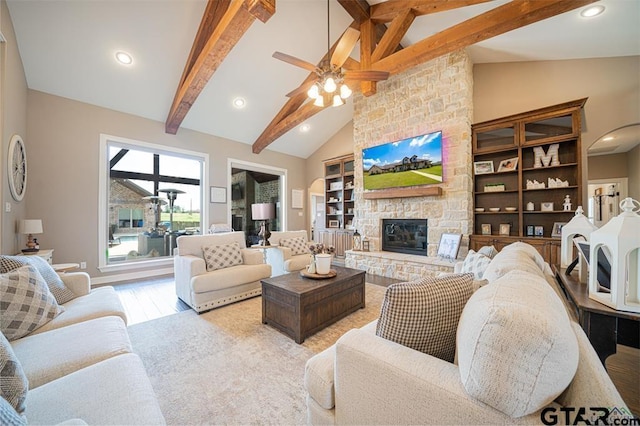 living room featuring beamed ceiling, light wood-type flooring, a fireplace, high vaulted ceiling, and recessed lighting