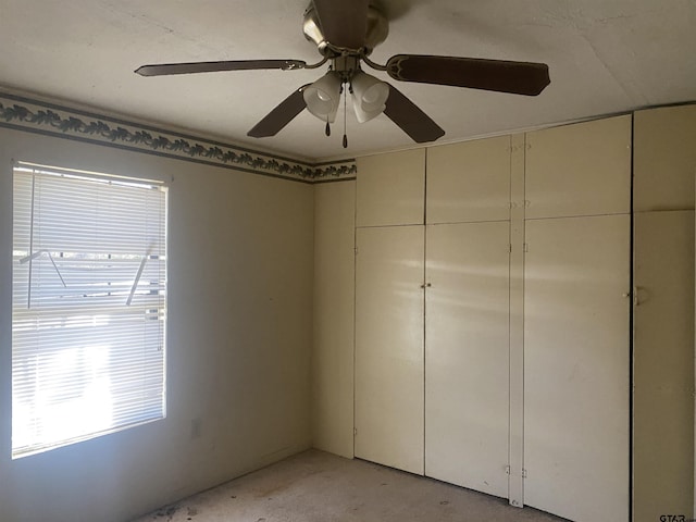 unfurnished bedroom featuring ceiling fan