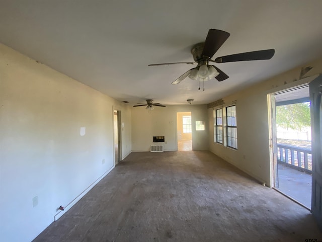 unfurnished living room featuring ceiling fan and plenty of natural light