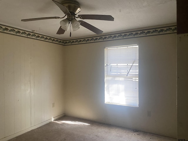 empty room featuring carpet floors and ceiling fan