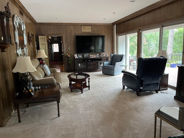 carpeted living room with wood walls and ornamental molding