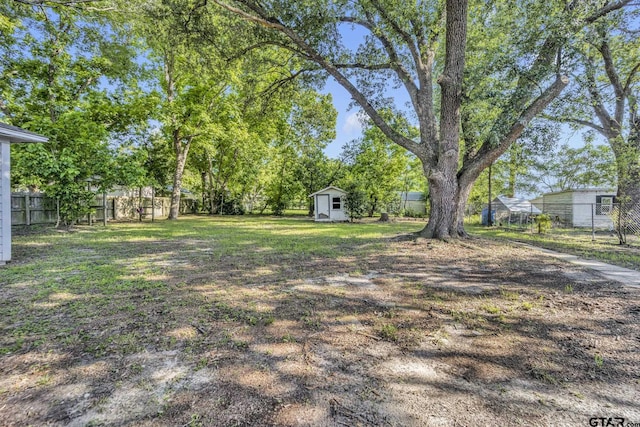 315 E Hubbard St, Lindale, TX 75771 - view of yard featuring an outdoor structure and a storage unit