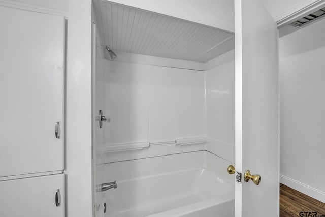 315 E Hubbard St, Lindale, TX 75771 - bathroom with bathtub / shower combination, baseboards, and wood finished floors