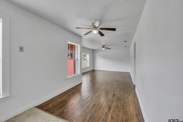 315 E Hubbard St, Lindale, TX 75771 - unfurnished living room featuring ceiling fan, baseboards, and wood-type flooring