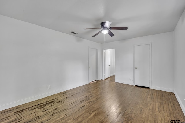 315 E Hubbard St, Lindale, TX 75771 - unfurnished bedroom with wood finished floors, baseboards, and ceiling fan