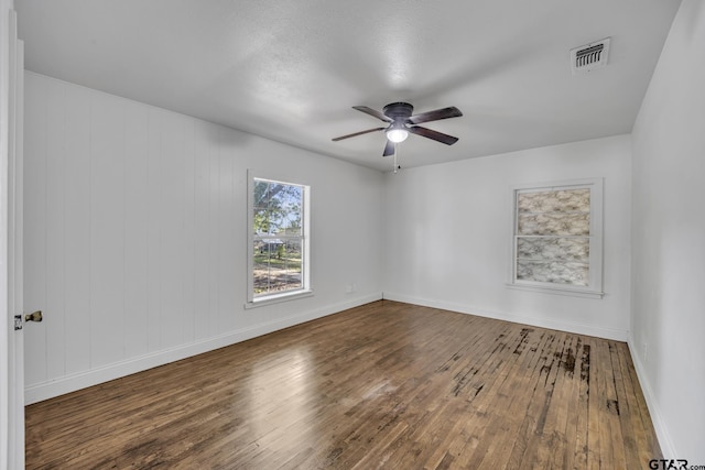 315 E Hubbard St, Lindale, TX 75771 - unfurnished room with hardwood / wood-style flooring, ceiling fan, and baseboards