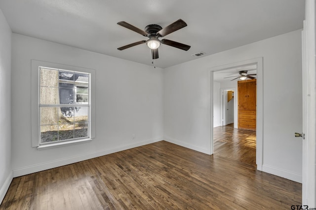 315 E Hubbard St, Lindale, TX 75771 - unfurnished room featuring a ceiling fan, dark wood-type flooring, and baseboards