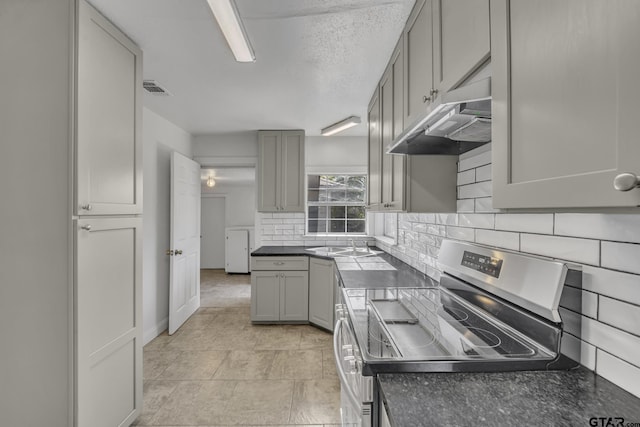 315 E Hubbard St, Lindale, TX 75771 - kitchen with electric range, gray cabinets, and dark countertops