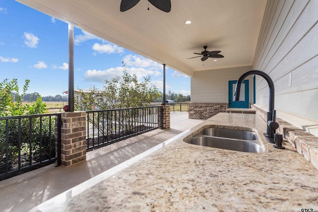 view of patio / terrace with ceiling fan and sink