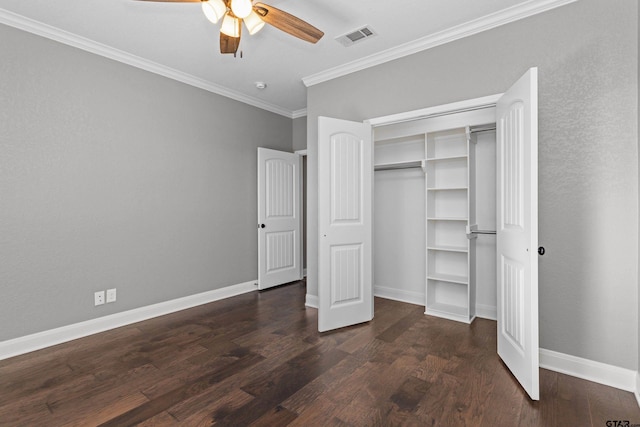 unfurnished bedroom featuring dark wood-type flooring, ceiling fan, a closet, and crown molding