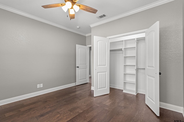 unfurnished bedroom with crown molding, ceiling fan, dark hardwood / wood-style floors, and a closet