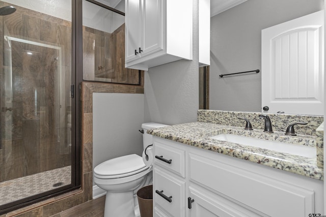 bathroom with walk in shower, wood-type flooring, vanity, and toilet