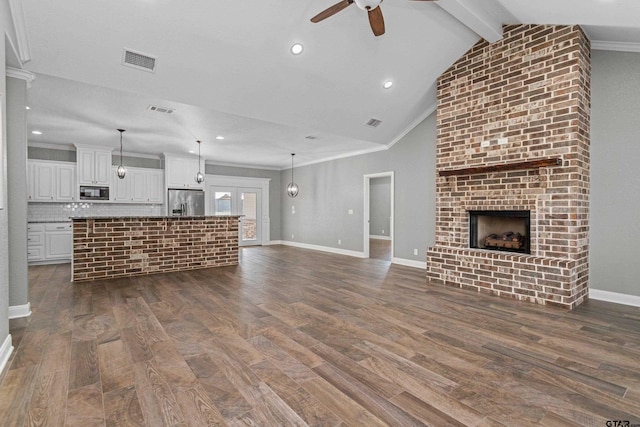 unfurnished living room featuring crown molding, vaulted ceiling with beams, and dark hardwood / wood-style flooring