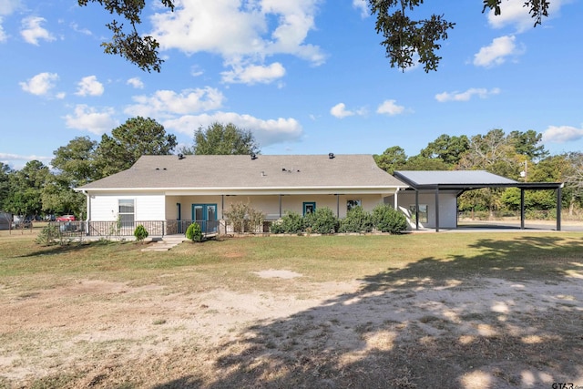 back of house featuring a yard and a carport