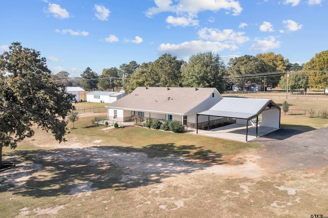 exterior space with a lawn and a carport