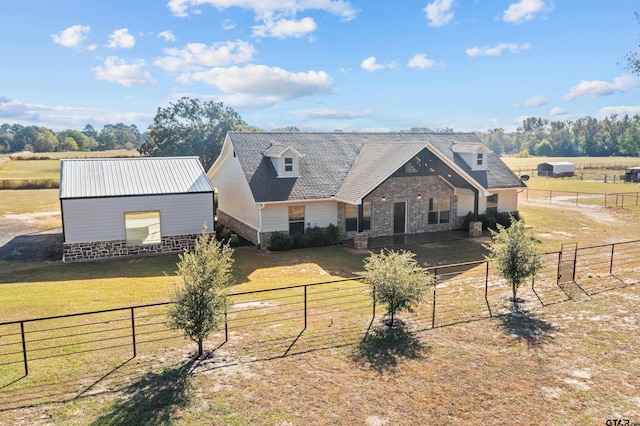 view of front of home featuring a front yard and a rural view