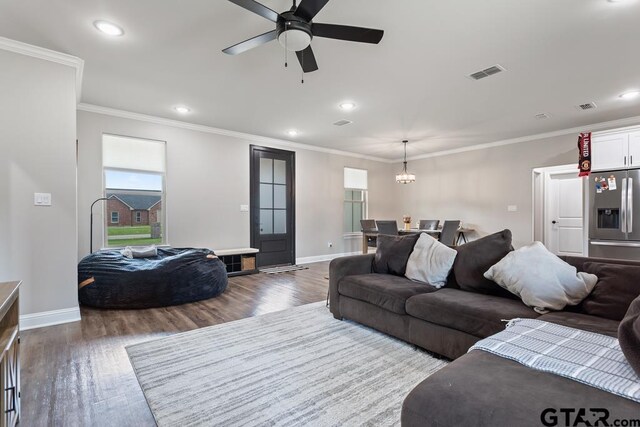 19308 Cedarpark Pl, Lindale, TX 75771 - living area featuring wood finished floors, recessed lighting, a ceiling fan, crown molding, and a chandelier