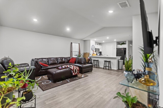 1106 Ripplewood Cir, Chandler, TX 75758 - living area featuring vaulted ceiling, light wood-style flooring, visible vents, and recessed lighting