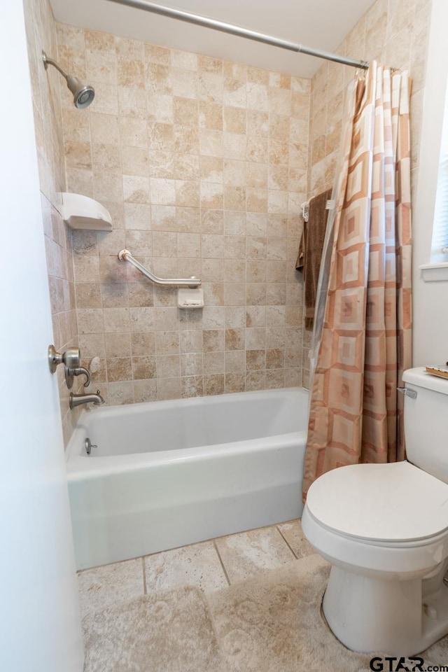 bathroom featuring shower / tub combo and toilet