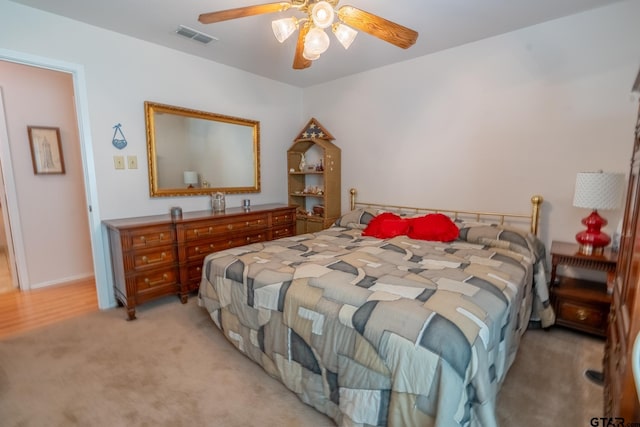 bedroom with light colored carpet and ceiling fan