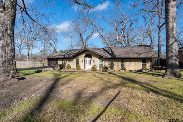 single story home featuring a front lawn