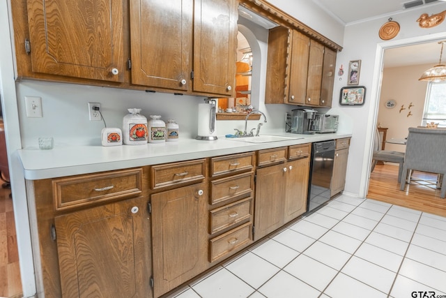 kitchen with light tile patterned flooring, dishwasher, sink, hanging light fixtures, and ornamental molding