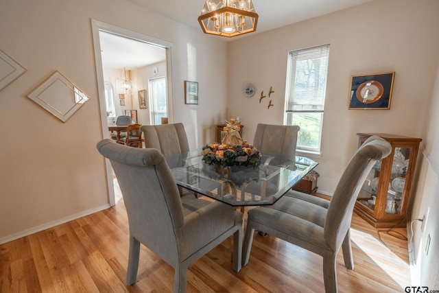 dining room featuring an inviting chandelier and light hardwood / wood-style flooring