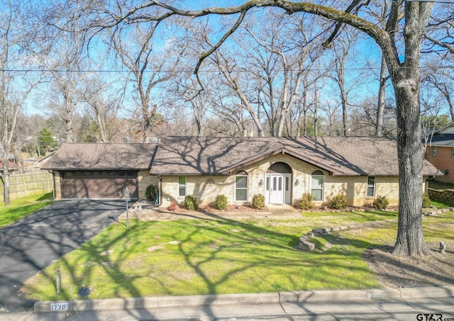 ranch-style house with a garage and a front lawn