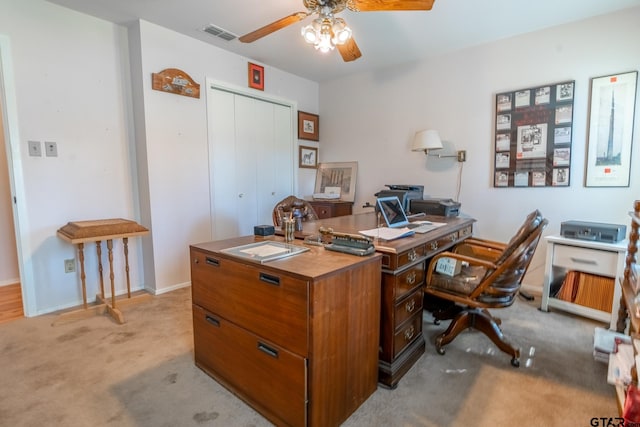 carpeted office space with ceiling fan