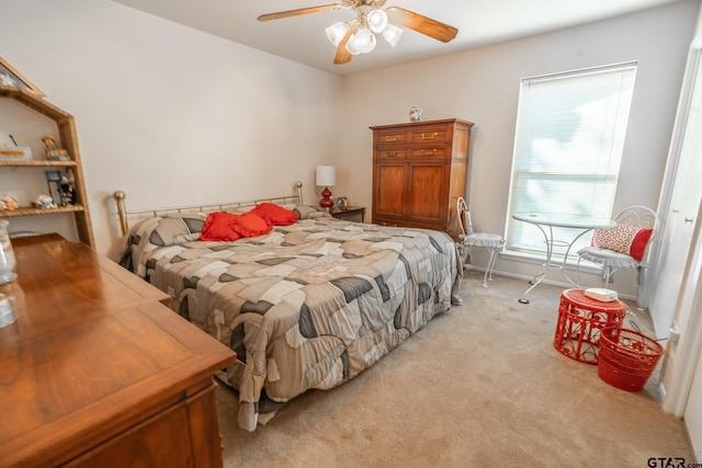 bedroom featuring light colored carpet and ceiling fan