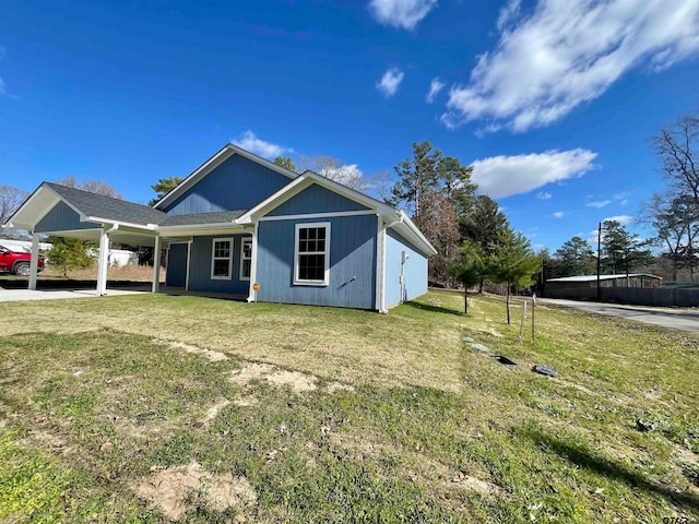 view of front of property with a front yard and a carport