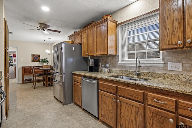 kitchen featuring tasteful backsplash, sink, ceiling fan, and appliances with stainless steel finishes