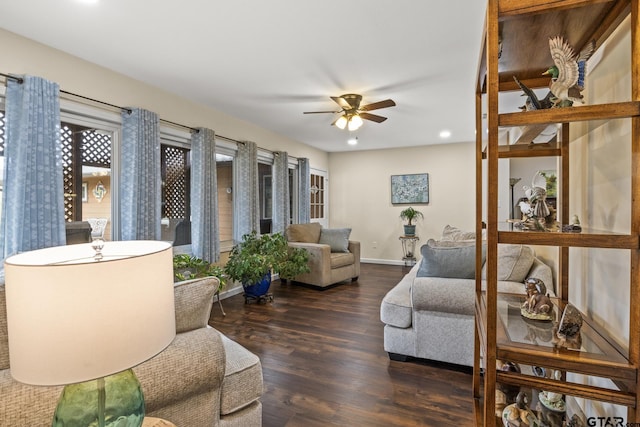 living room with dark hardwood / wood-style flooring and ceiling fan