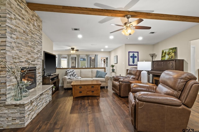 living room featuring ceiling fan, dark hardwood / wood-style floors, a fireplace, and beam ceiling