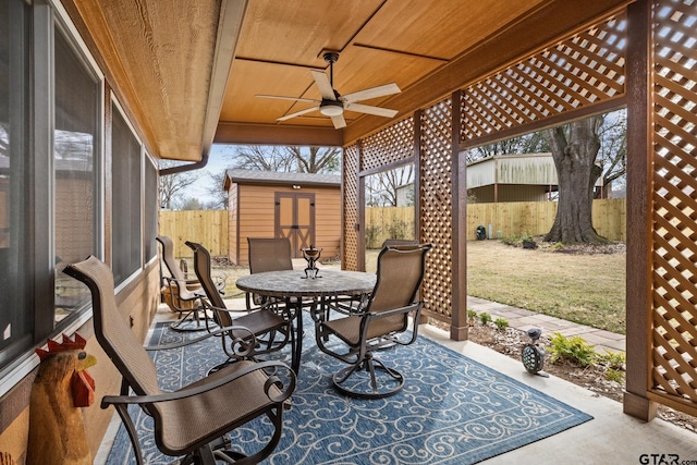 view of patio with a shed and ceiling fan