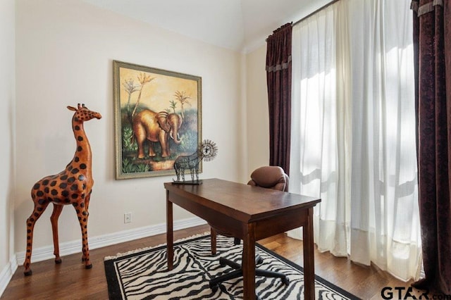 home office featuring baseboards and dark wood finished floors