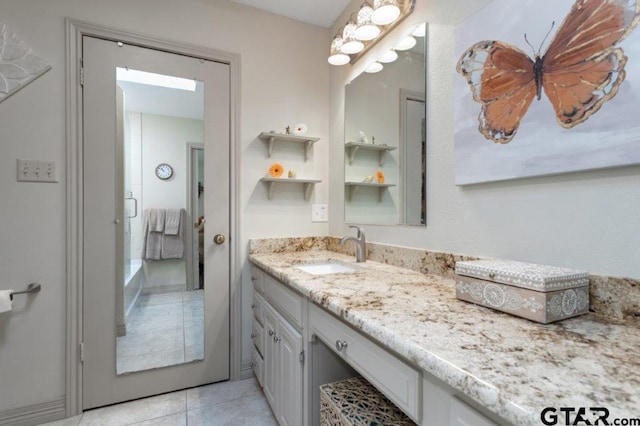 bathroom with tile patterned flooring and vanity