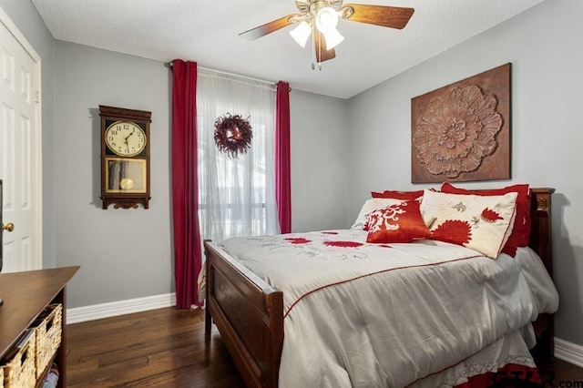 bedroom with ceiling fan, dark wood-type flooring, and baseboards