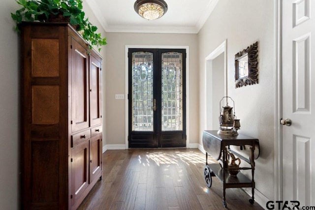 entrance foyer featuring french doors, ornamental molding, wood finished floors, and baseboards