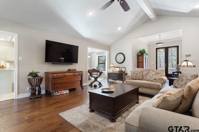 living area with dark wood-style flooring, baseboards, vaulted ceiling with beams, and french doors