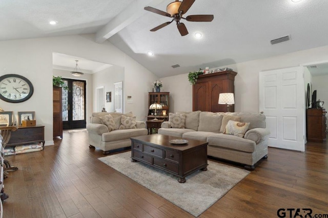 living area with dark wood-type flooring, visible vents, vaulted ceiling with beams, and a ceiling fan