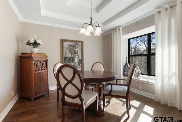 dining space featuring baseboards, a tray ceiling, and dark wood-type flooring